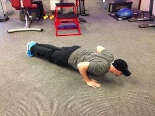 Hands are slightly wider than shoulder width apart (normal pushup width).