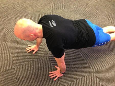 Offset Pushup Keep your abs braced and body in a straight line from toes to shoulders.