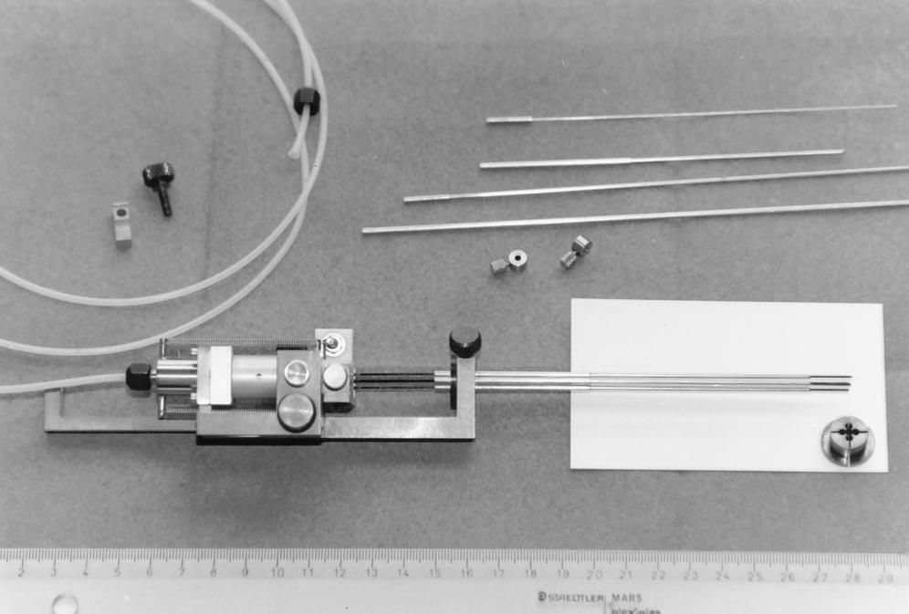 AJNR: 18, June 1997 THALAMIC STIMULATION 1099 Fig 9. Photograph of the holder of the five exploratory electrodes with the electrodes and a centimeter marker. Fig 10.