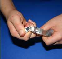 STEP 9 Remove plastic cap from diluent syringe by bending up and