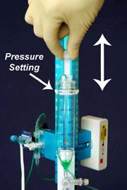 Setting a Pressure Threshold on System Raise or lower the drip chamber to the pressure setting described by the doctor The