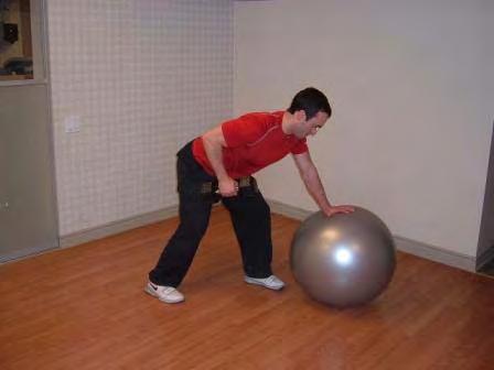 Step the leg on the dumbell side back and the other leg closer to the ball.