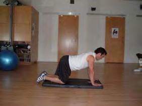 Keep your abs braced, pick one foot up off the floor, and slowly bring your knee up to your chest.