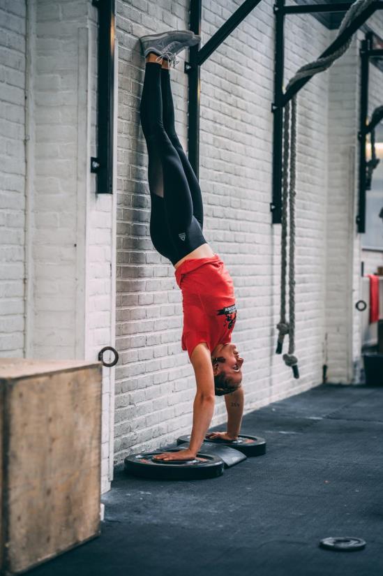 HANDSTAND PUSH-UP Each repetition starts with the athlete standings on their hands, with the