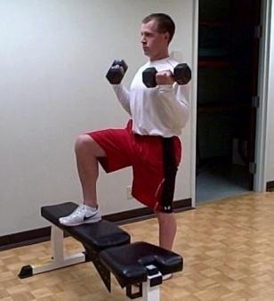 Be sure to engage the core and squeeze the glutes, and then slowly pivot at the elbows and raise the dumbbells to your