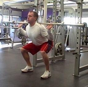 Return from the squat and press the dumbbells over head, pause for a second and slowly return the weight to your shoulders.