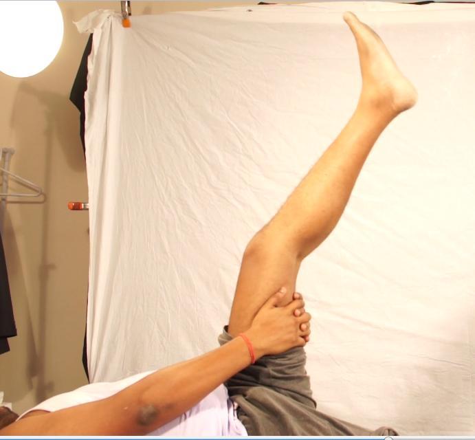 self-stretching exercise for the hamstring muscle. The person is doing an active contraction of the quadriceps muscle to stretch the hamstring muscle.