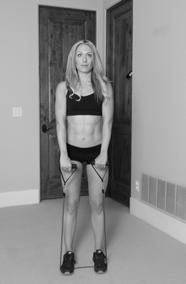 ) In a standing position, position the feet over top of the middle of the resistance band.