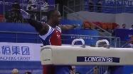 arms Then, the gymnast performs pommel horse while spinning his body A person behind the pommel horse takes pictures to the gymnast After, the gymnast stands on his hands, turn and jumps to land on