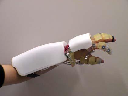 of the developed system is investigated in section 4. II. EXOSKELETON ASSISTIVE HAND This section introduces an exoskeleton assistive hand (Figs.