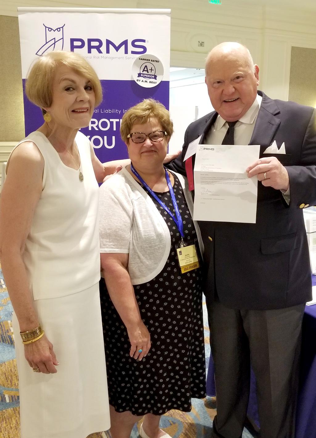 PRMS Executive Vice President JACKIE PALUMBO presents GAP President JOHN LOONEY, MD along with SUSAN LOONEY a letter of agreement for the PRMS endowment.