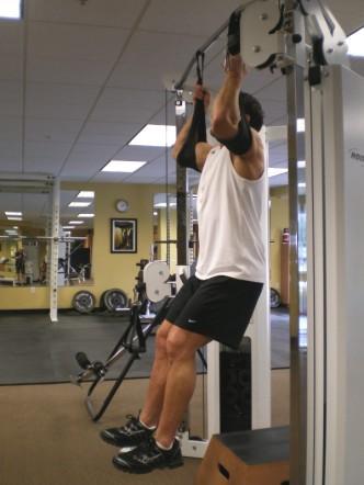 5 Hanging High Raises - Hang from a pull-up bar (or with arms inside straps) with your