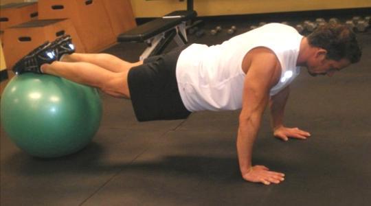 18 Ball Tuck-Ins -In push up position, place your feet on the ball. Hold your spine straight and maintain head and neck alignment.