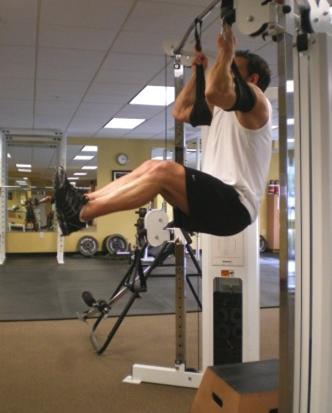 32 Hanging Raises - Hang from a pull-up bar (or with arms inside straps) with your legs slightly bent. Raise your legs by bringing your knees up toward your chest.