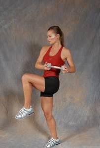 45 Standing Oblique Crunch - Begin with your feet shoulder width apart and arms extended towards the