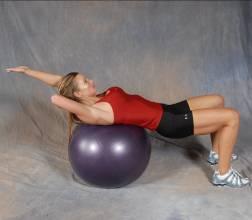 2 Opposite Crunches - Lie across the top of a stability ball with your feet placed firmly on the floor.