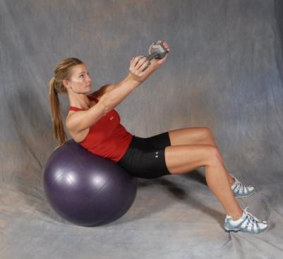 4 DB Side Reaches - Lie across the top of a stability ball with your feet placed firmly on the floor.