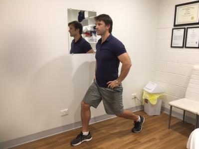 Maintain an upright trunk and slowly lower the rear knee toward the ground as far as is comfortable. Return to the starting position.