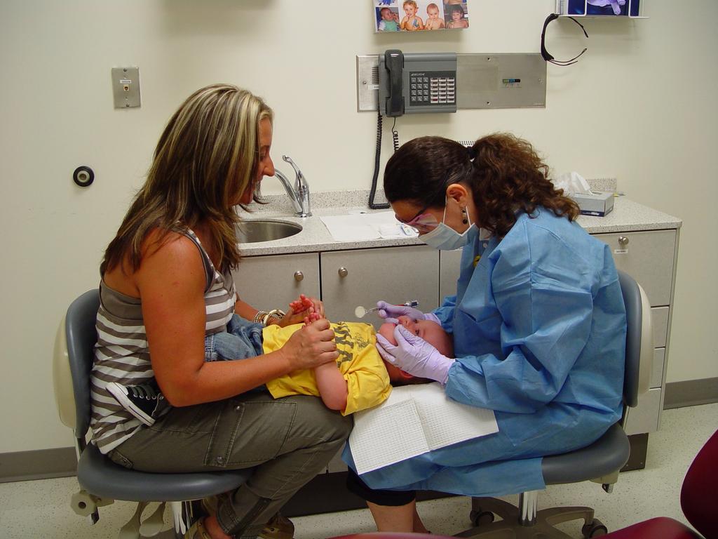 Figure 1. Knee-to-knee dental examination position. Knee-to-knee is the most practical and comfortable way to position young children during the examination.