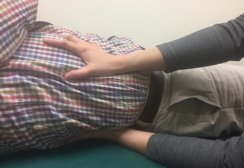 Patient is supine. Sit on the side to be treated and make a plastic contact along the 12 th rib with middle finger. The main leverage is slightly lateral to the costovertebral junction.