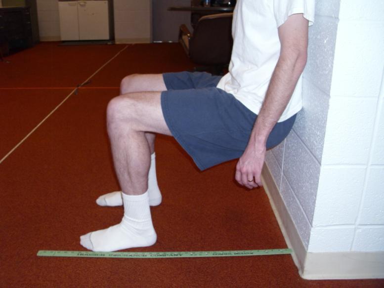 53 correct wall sit position was feet flat and shoulder width apart, knees at 90 degrees, shoulders against the wall, and arms hanging straight down (see Figure 2.1).