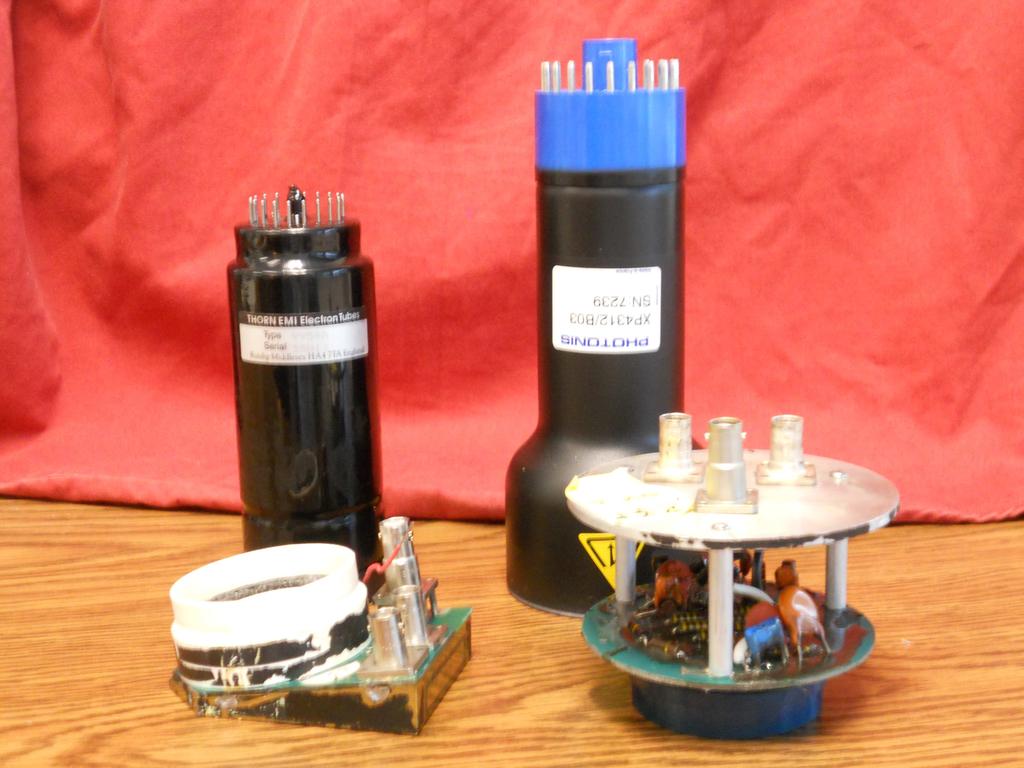 Figure 2: Photograph of the 2-in EMI 9954A and 3-in Photonis XP4312B PMTs and their associated voltage dividers that are current part of the CLAS TOF system and will be used for the CLAS12 panel-1a