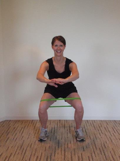WALKING SQUAT Secure exercise band just above the knees. Perform a mini squat.