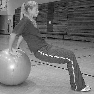 place hands on floor and legs on top of ball.