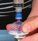 Put the immunoglobulin bottle onto a flat surface and push spike through the rubber stopper Attach the syringe onto the mini spike Carefully turn the bottle up side down and gently pull back on