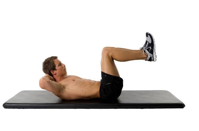 Abdominal Curl: Start sculpting the abs with this Lying on your back with your feet down on the floor or in tabletop to challenge as pictured, knees squeezed together and the fingers interlocked