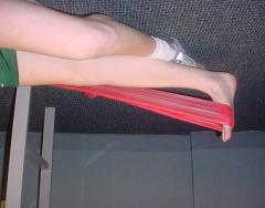 Theraband exercises: Ankle Plantarflexion: Start by tying the theraband around a table leg.