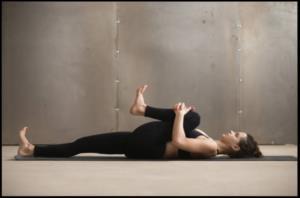 Knee to opposite shoulder 1. Lie on your back with your legs extended and your feet flexed upward. 2. Bend your right leg and clasp your hands around the knee. 3.