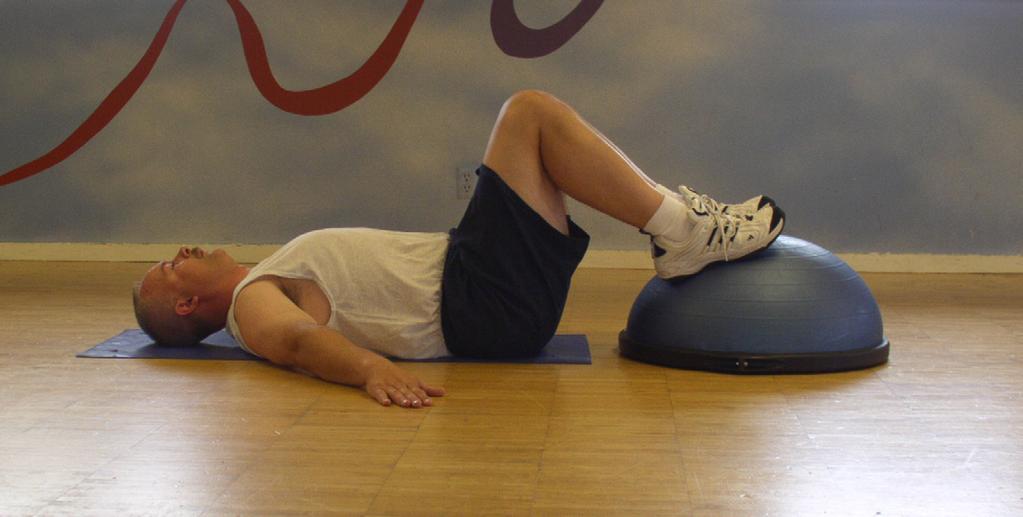 While contracting your Glutes, Hamstrings, and Abdominals elevate your hips up off the