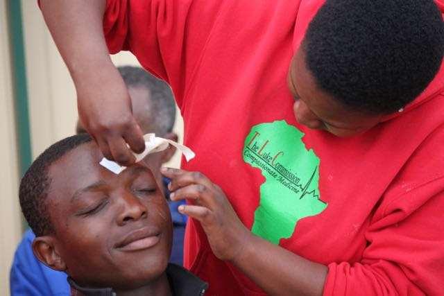 TLC staff member gently removes the patch over Ndumiso s eye that day after Dr. Cohen s difficult cataract surgery. His great-grandfather and grandmother each had unsuccessful eye operations.
