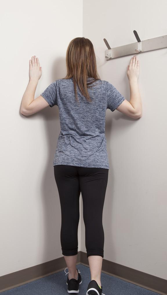 Lean onto the front leg as you bring your head and chest toward the corner. You should feel a light stretch in your shoulders. Hold this position for 20-30 seconds.