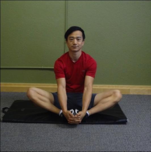Hip Conditioning Program Instructions: Sit on a mat and bend legs so the soles of your feet are touching.