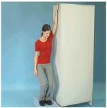 Physiotools LTD Stand in a walking position. Bend your elbow and support the forearm against a door frame or corner.