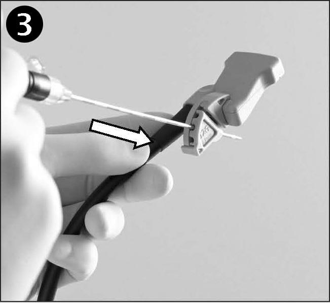 Hold the needle guide in your right hand with the lip at the bottom and pointing away from you. Align the two grooves on the transducer with the two ridges on the needle guide.