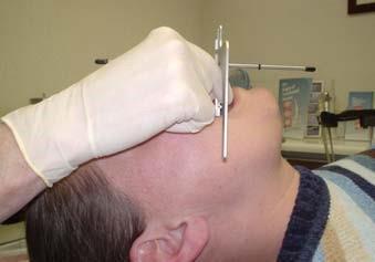 You can look at the vertical rod related to the facial midline better from behind the patient.