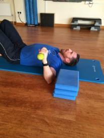 Eccentric External Shoulder Rotation Start lying on your back, knees bent up