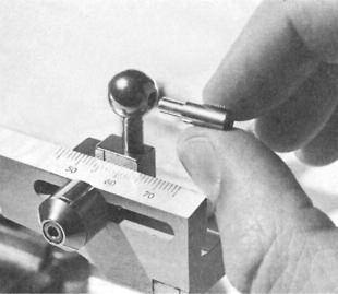 The recorder is transferred to the articulator by indexing the posterior reference pins provided in the lateral extremities of the mounting studs (Fig. 55).