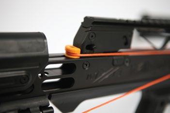 Continuing to hold the release lever to the right, pull remaining hook and attach it to the bowstring on the opposite side of the crossbow rail. 6.