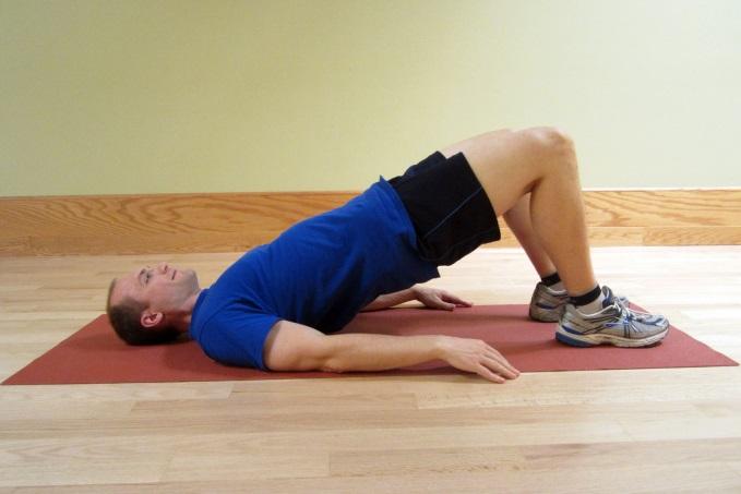 Bridge Exercise - Starting Position Lie on your back with your knees bent to prepare for the bridge exercise.