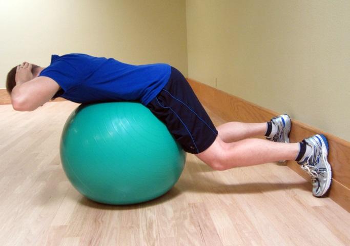 Perform 2 sets of 10 repetitions, once per day. Ball Extension - Starting Position Position your feet against a wall to assist you with your balance.