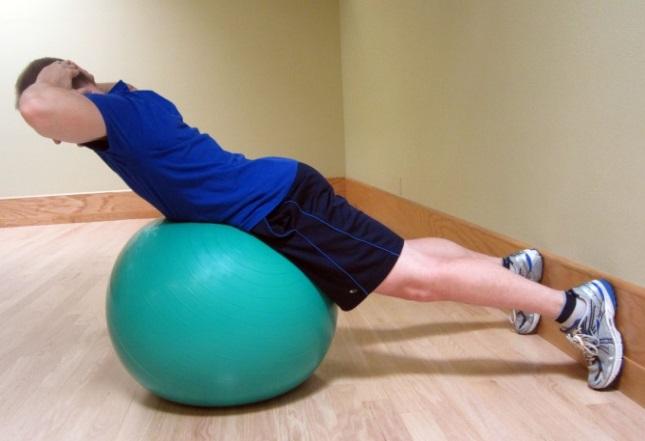 Ball Extension From your starting position, slowly raise your upper body until you have a slight arch in your back. Your legs stay straight. Keep the movement pain free.
