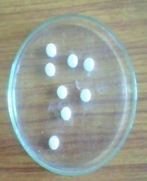Five circular tissue papers of 10 cm diameter are placed in a petridish with a 10 cm diameter. A tablet is carefully placed on the surface of the tissue paper.