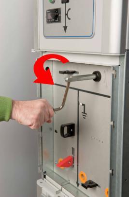 Busbar earthing panel to ON-position (MANUAL OPERATION): Note: see starting position on page 3 Push the red handle down and insert the operating handle in the opening (see Figure 1-6).