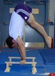 with head in, until body rolls up with back and hips directly over hands Continue pressing legs from pike handstand