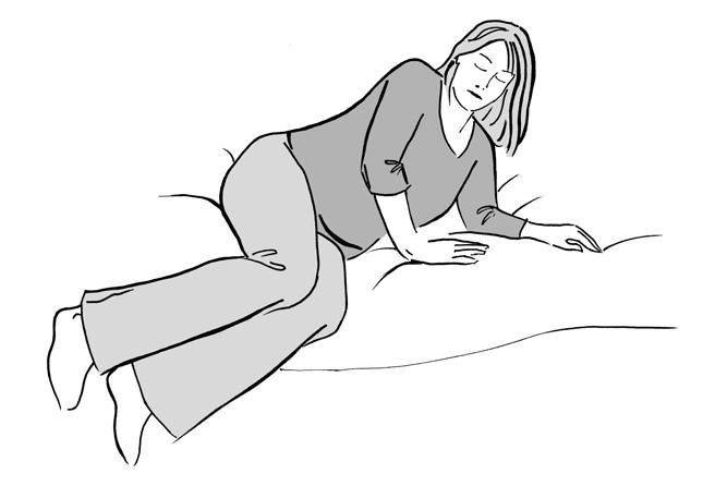 Lower your head and shoulders sideways down onto the pillow, keeping your knees bent and together, lift your legs up at the same time.