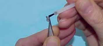Squeeze the lower part of the handle of the bracket holder/ tweezer to grab and